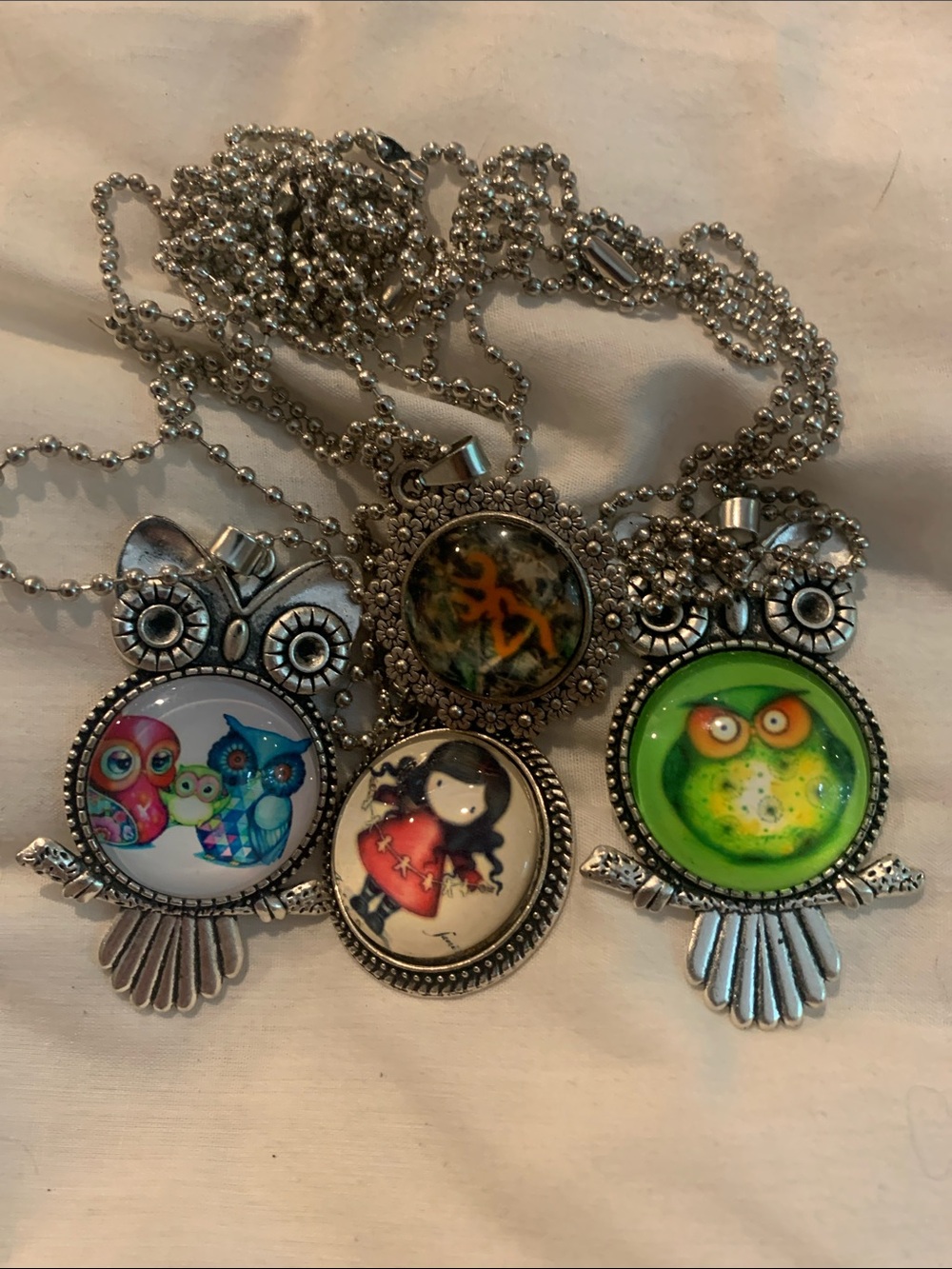 A collection of 4 -Color Cabochons necklaces. Owls browning Deer and pink girl
